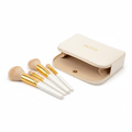 4-piece face makeup brush set with white and gold handles in premium travel pouch